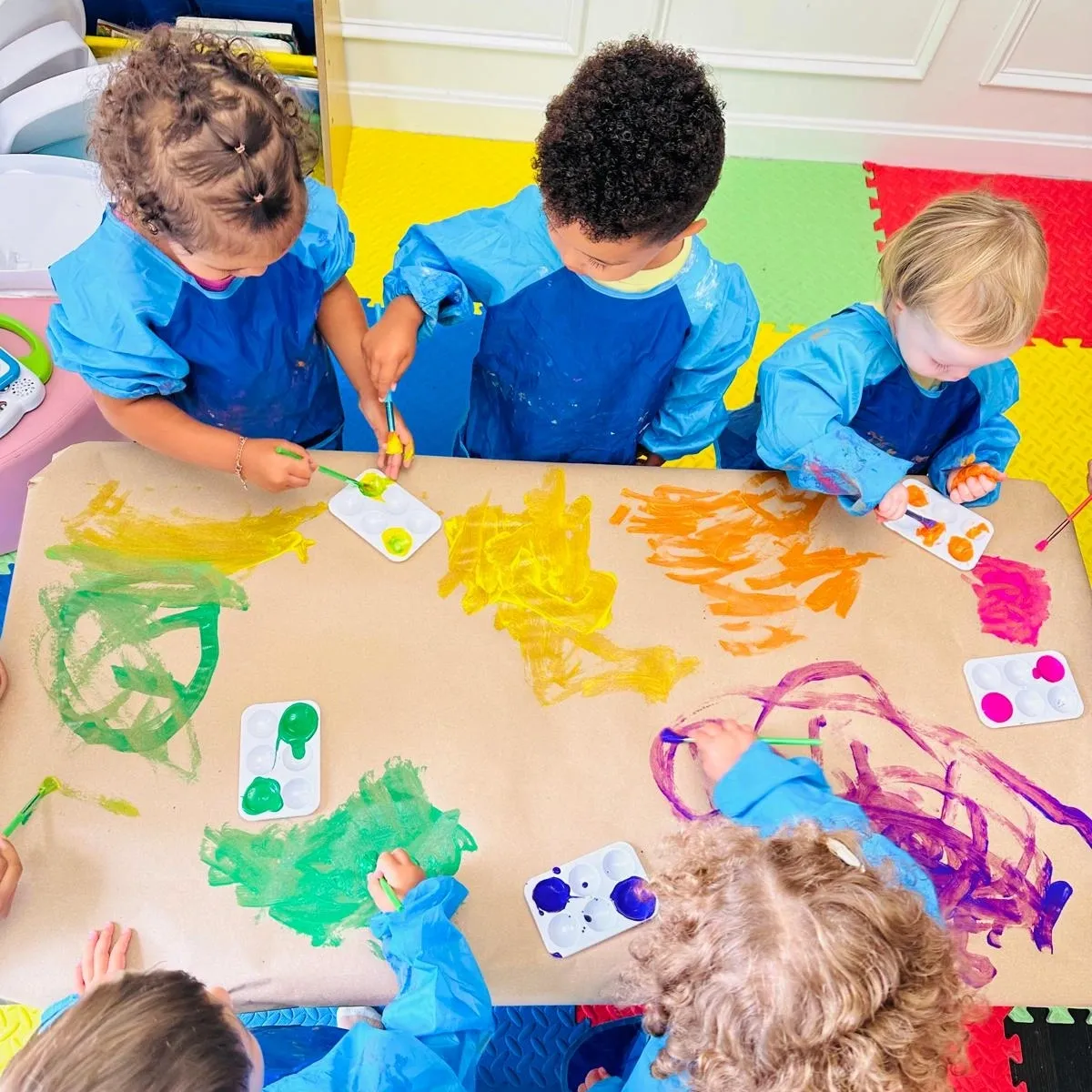 Children enjoying a creative painting activity at Care's Corner Childcare