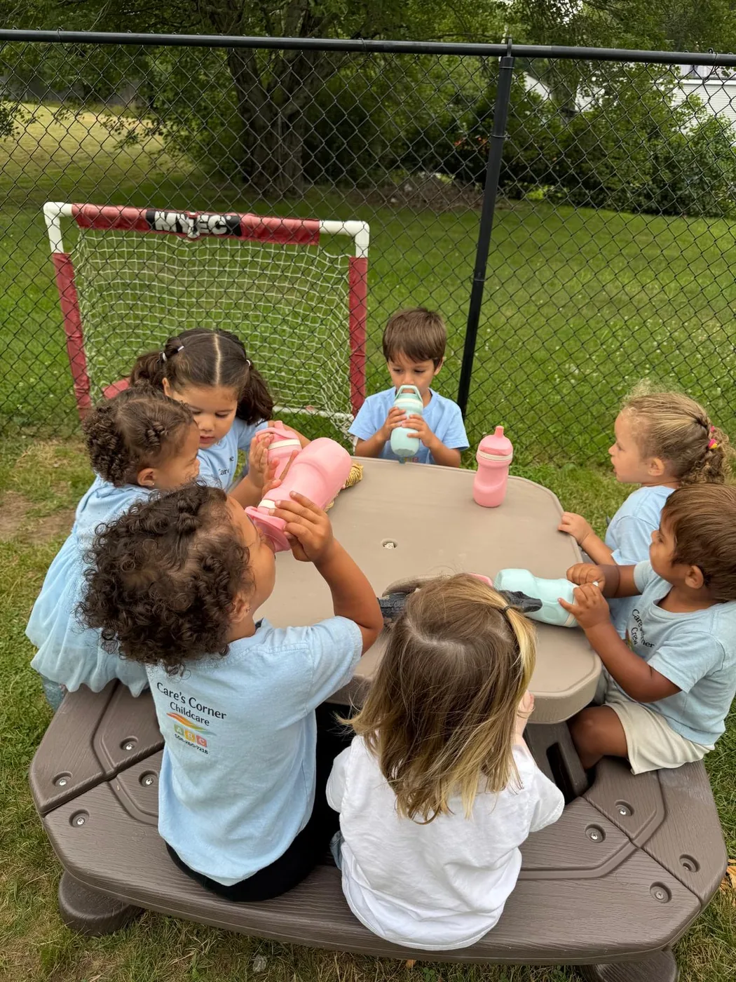 Children sharing outdoor time together at Care's Corner Childcare