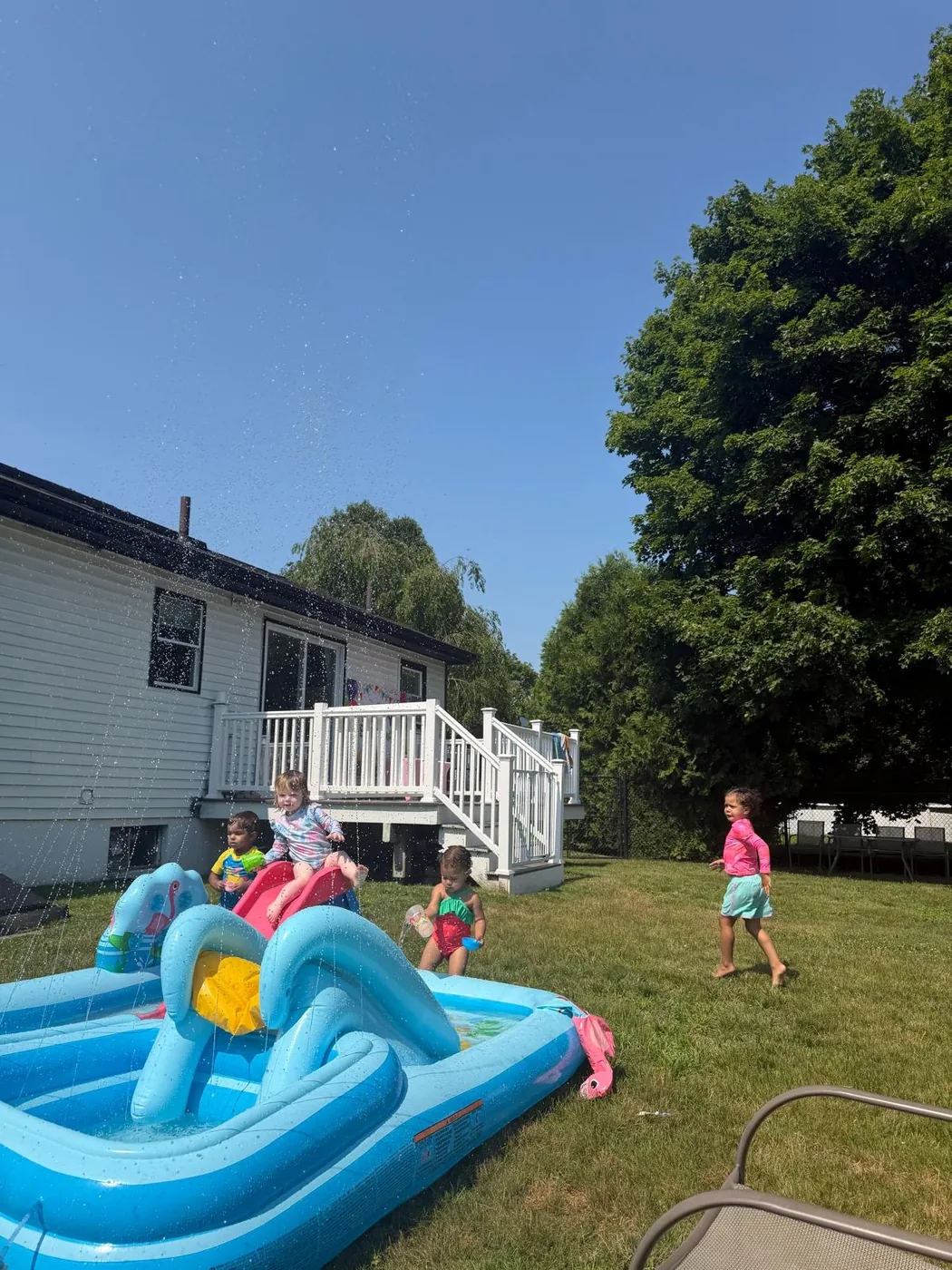 Children enjoying seasonal water play outdoors